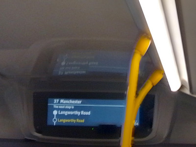 An electronic sign on a bus shows two consecutive stops called Langworthy Road